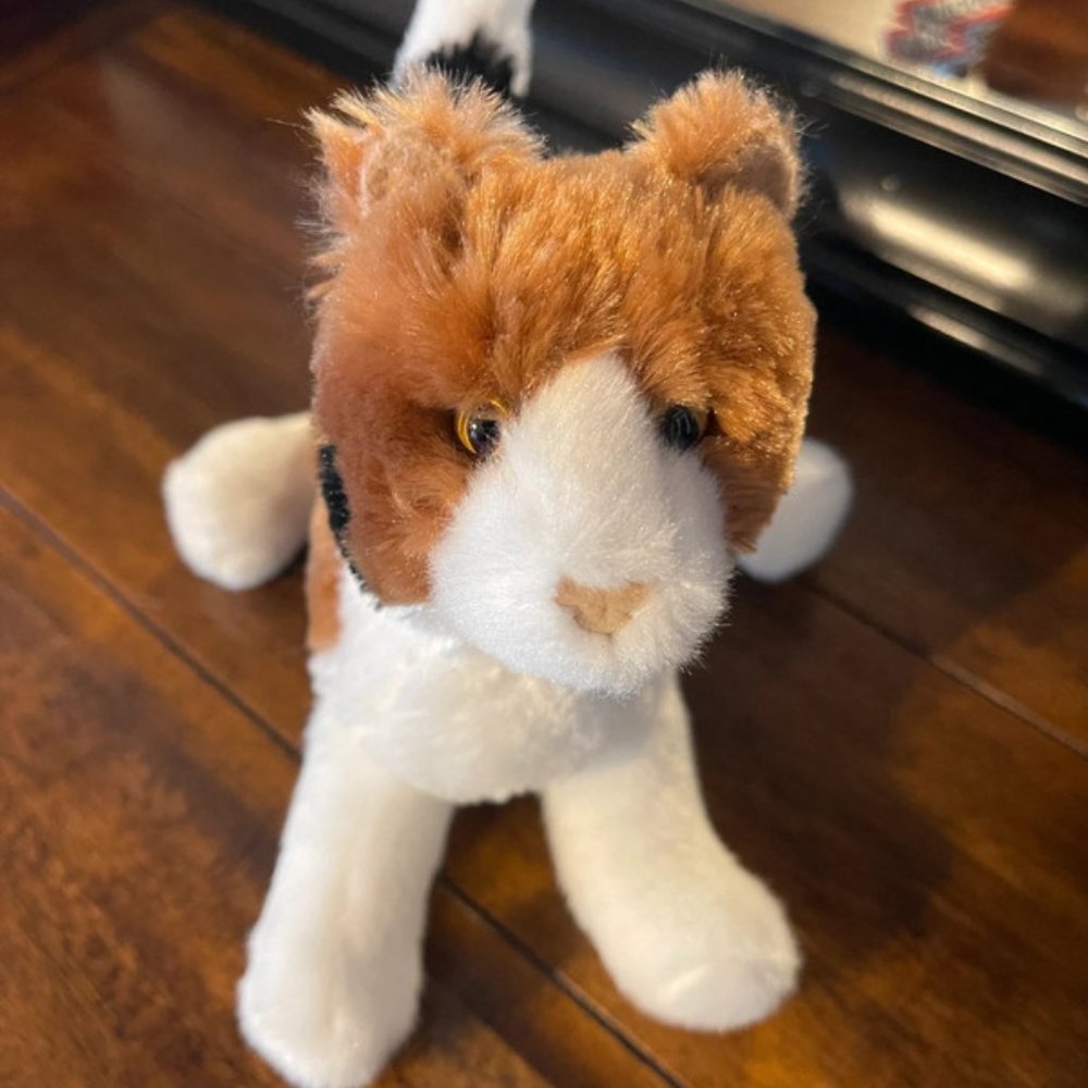 Small calico kitty cat by plush stuffed animal